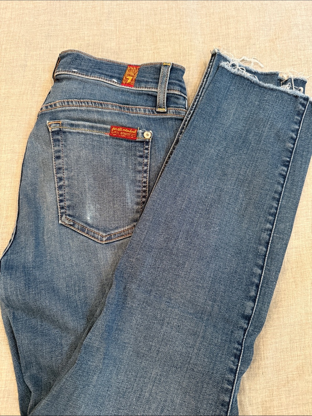 7 For All Mankind Skinny Jeans in Medium Blue with Frayed Hem
